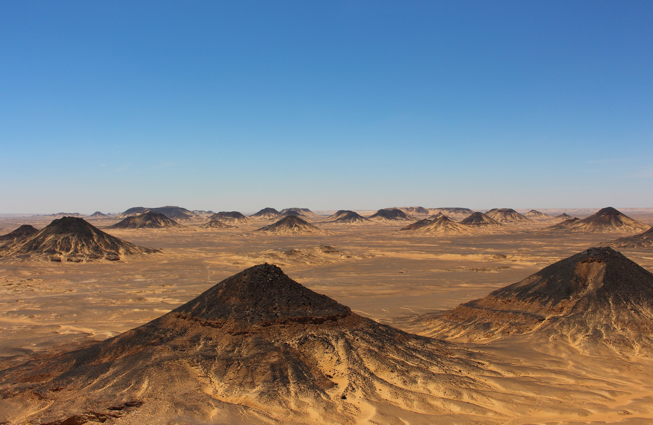 Black capped hills in a desert area