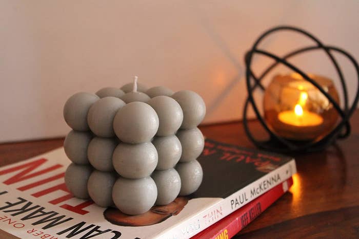 A grey cloud bubble shaped scented candle