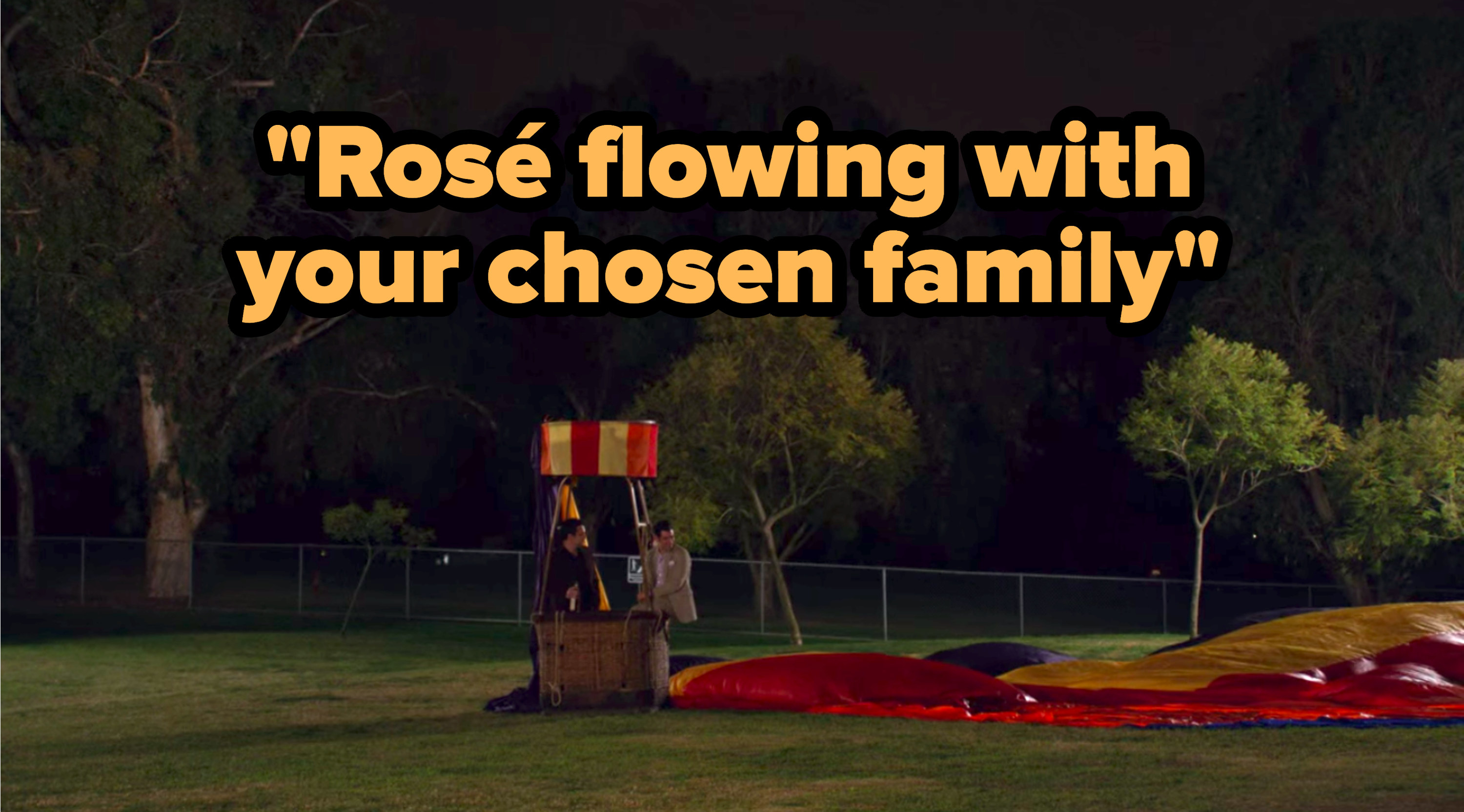 &quot;Rosé flowing with your chosen family&quot; written over Nick and Schmidt from &quot;New Girl&quot; standing in a grounded, deflated hot air balloon