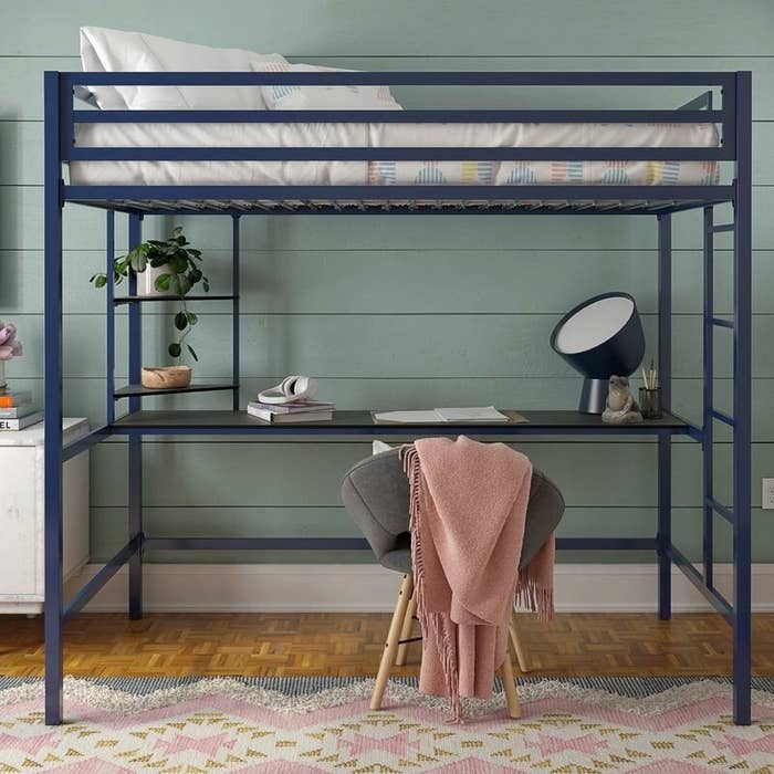 The metal loft bed in navy blue with attached bottom desk