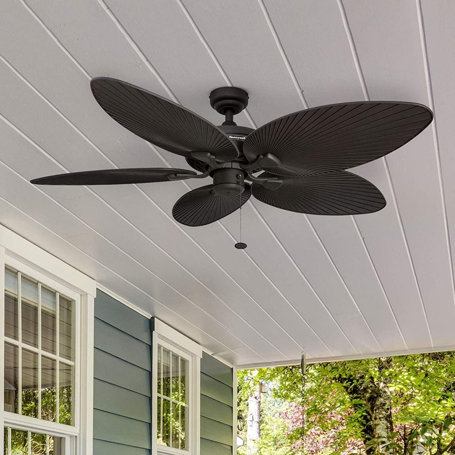 the five palm leaf ceiling fan installed in a roofed outdoor patio