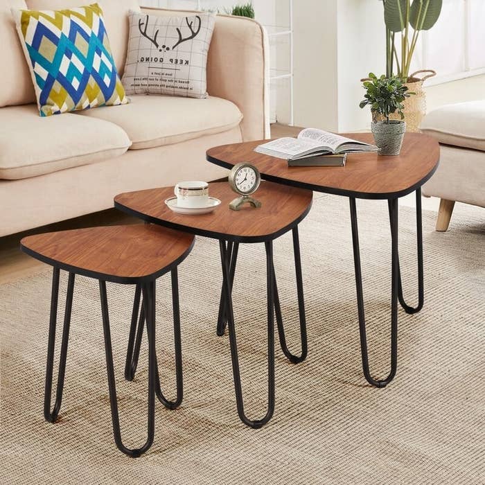The trio of wood and black nesting tables