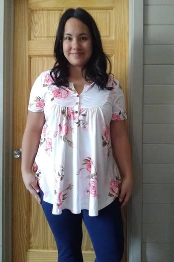reviewer wearing the tunic in pink floral print 