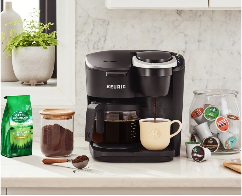 A black Keurig K-Duo coffee maker with two brewing systems; 1 for a single cup using k-pods and 1 for a 12 cup carafe of coffee