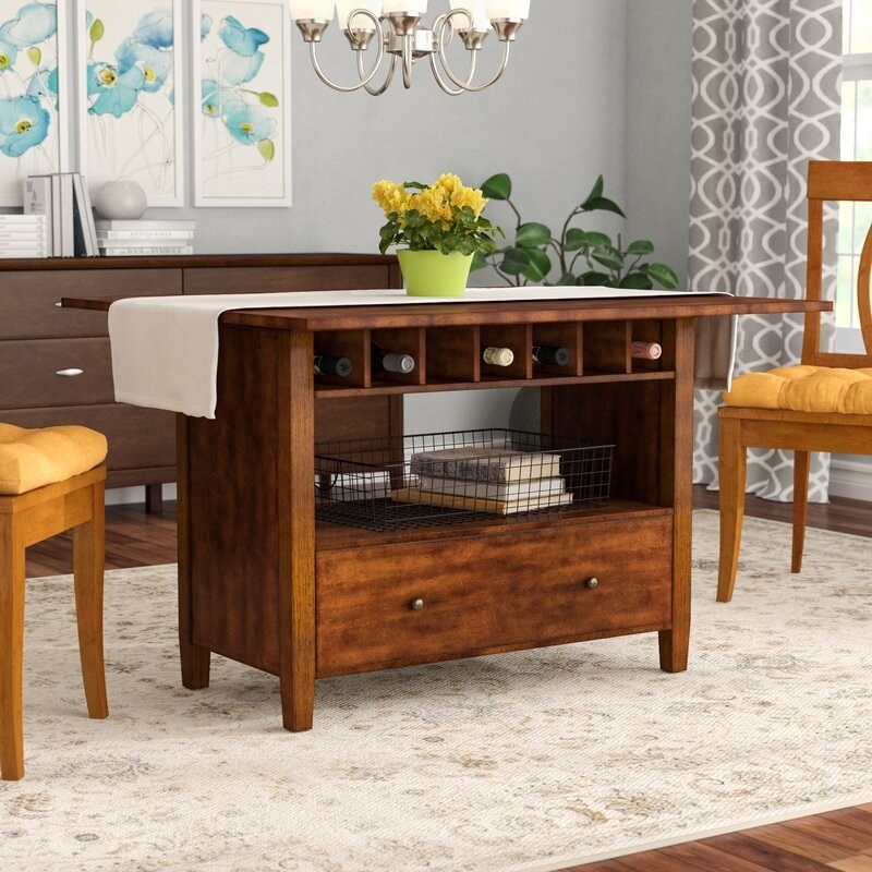 The dining table with bottom pull-out drawer, middle space for storage, and cubbies for wine bottles