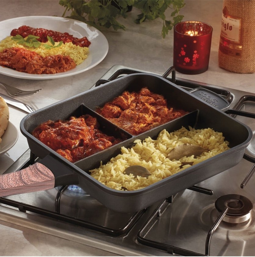 A non-stick, 3 compartment skillet filled with 3 different foods