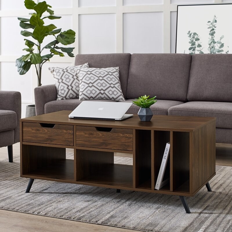 The wooden coffee table with two pull-out drawers, two cubbies, and three vertical drawers 