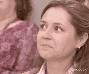a gif of pam from the office smiling and nodding approvingly