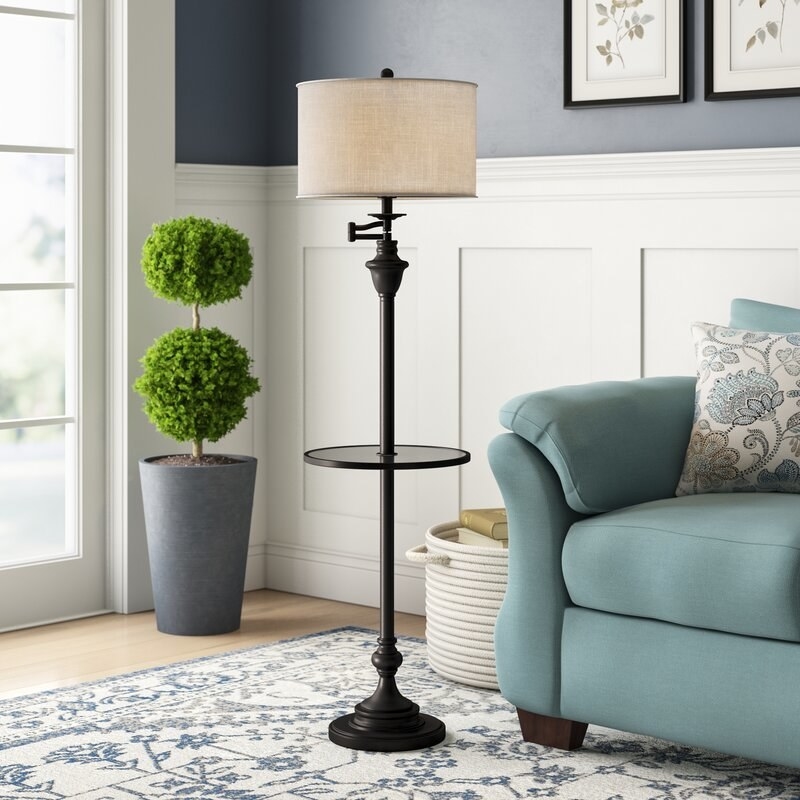 The floor lamp with circular shelf attached in the middle