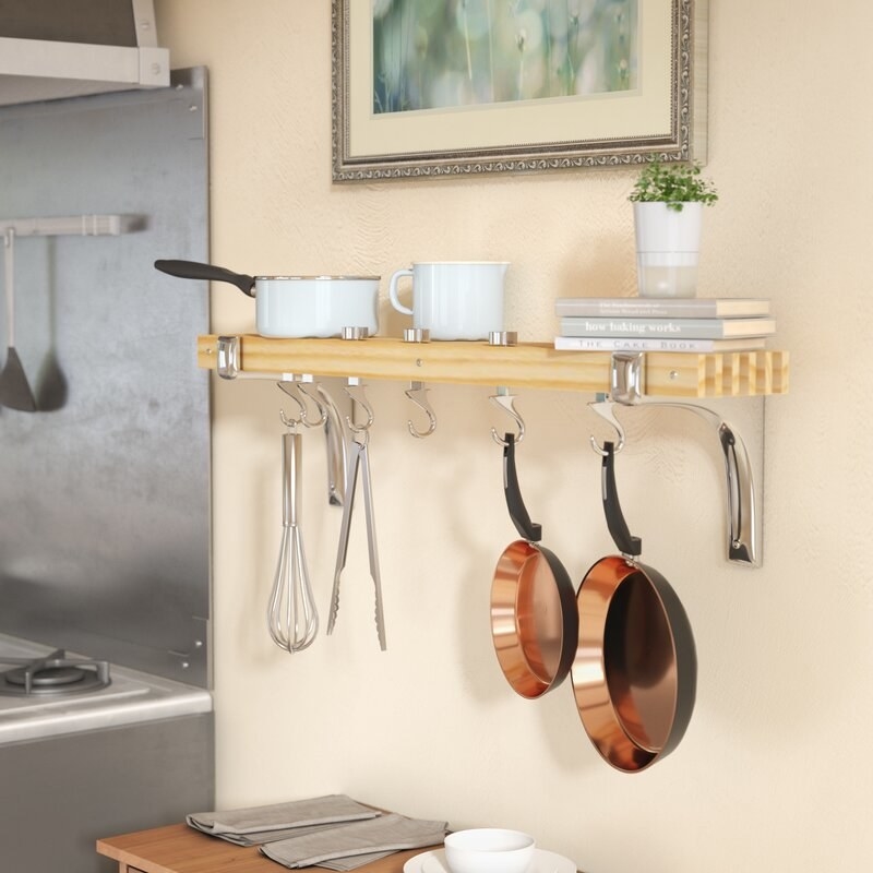 The wall pot rack with attached wooden shelf