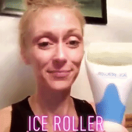 Reviewer using the ice roller on their face 