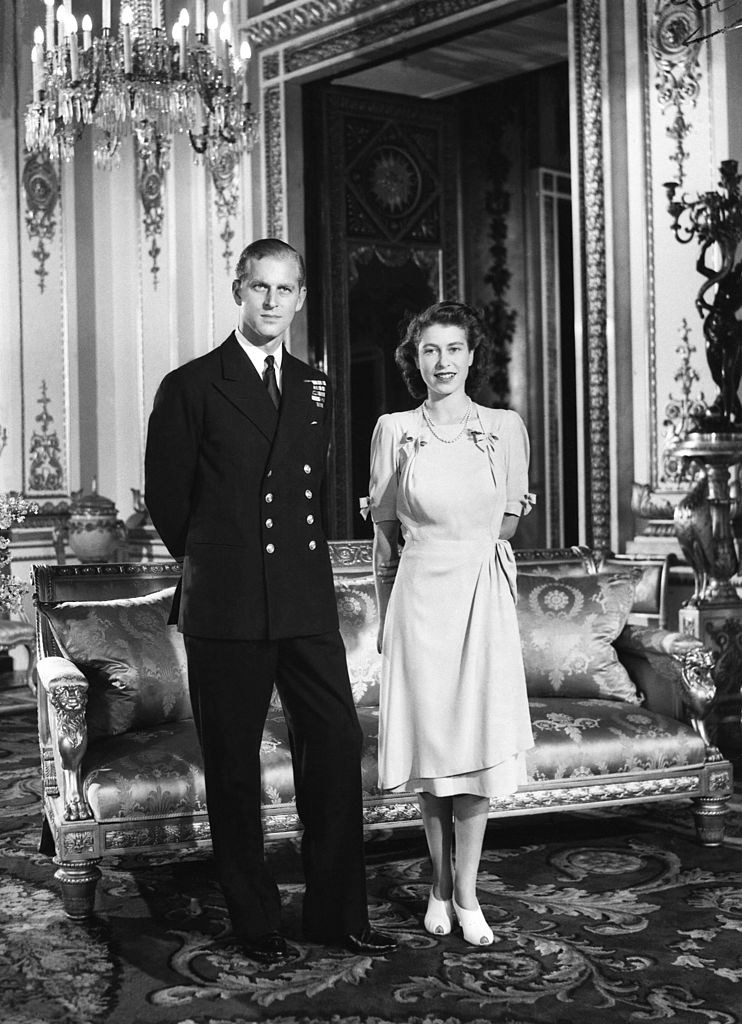 Prince Philip and Elizabeth standing in a grand room