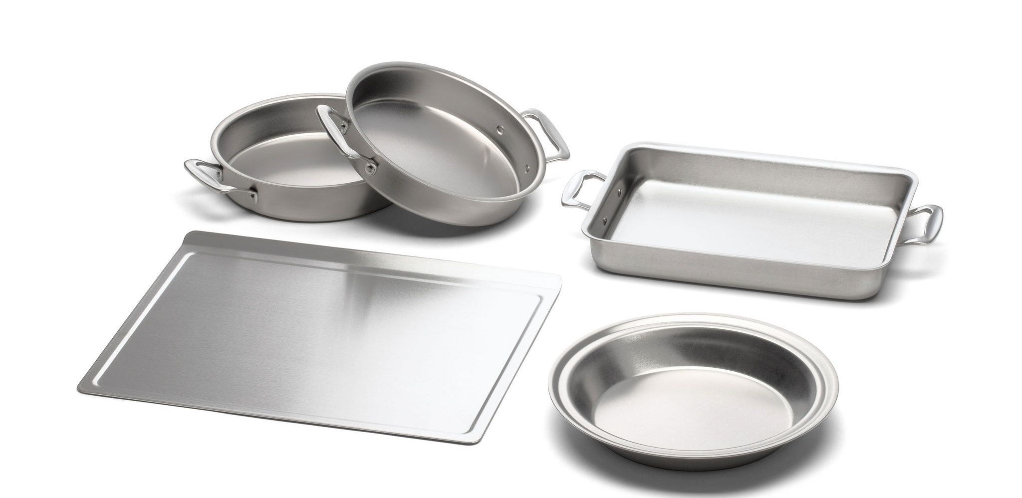 a sheet tray, three round pans, and a rectangular pan