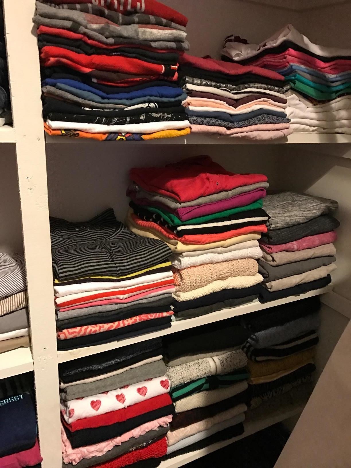 a reviewer photo of a closet filled with lots of neatly folded T-shirts 