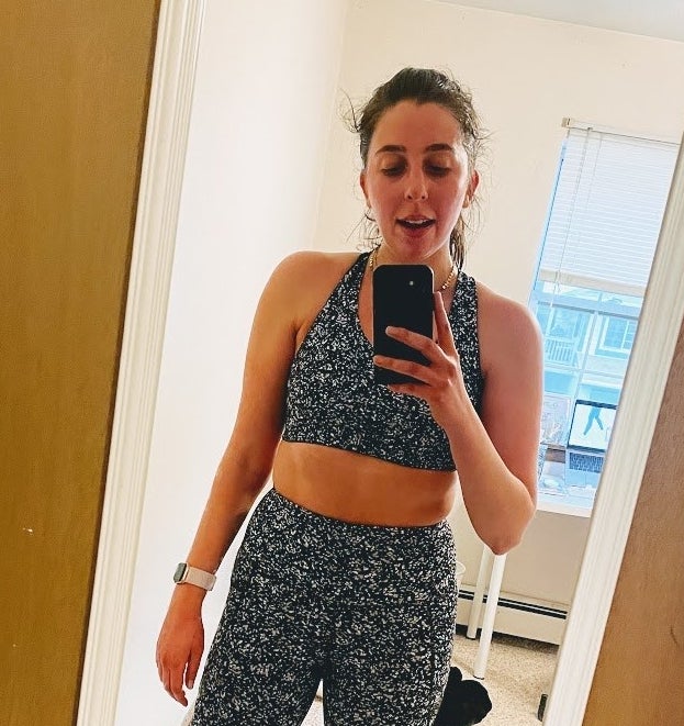 the author wearing the sports bra in a black and white spotted print with the matching leggings
