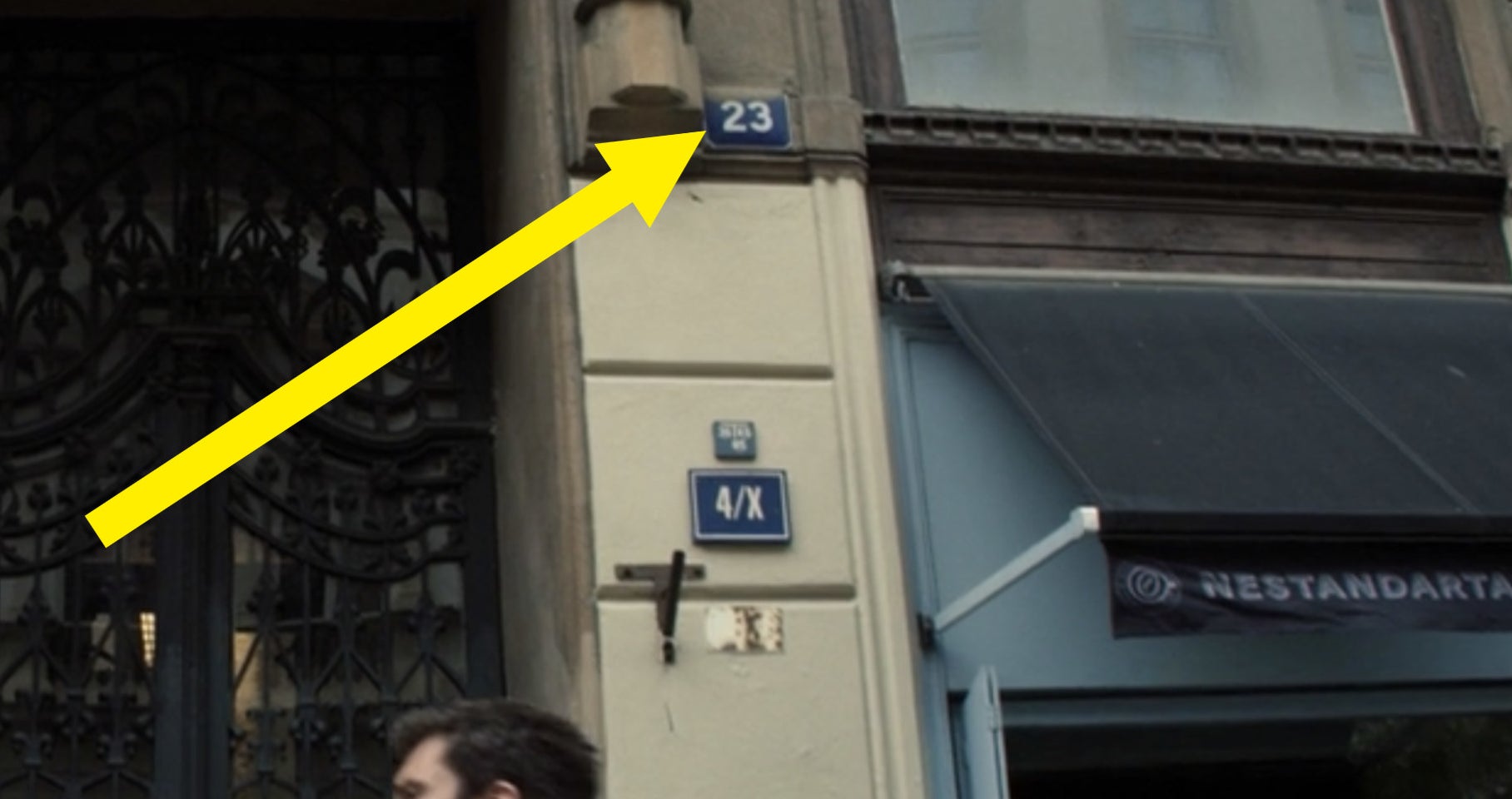 A yellow arrow pointing to &quot;23&quot; on a building