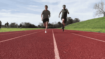 Two guys running on a track