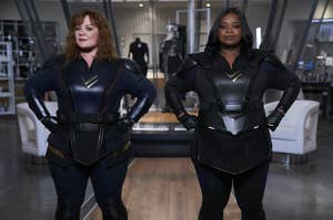Emily and Lydia posing in their superhero suits