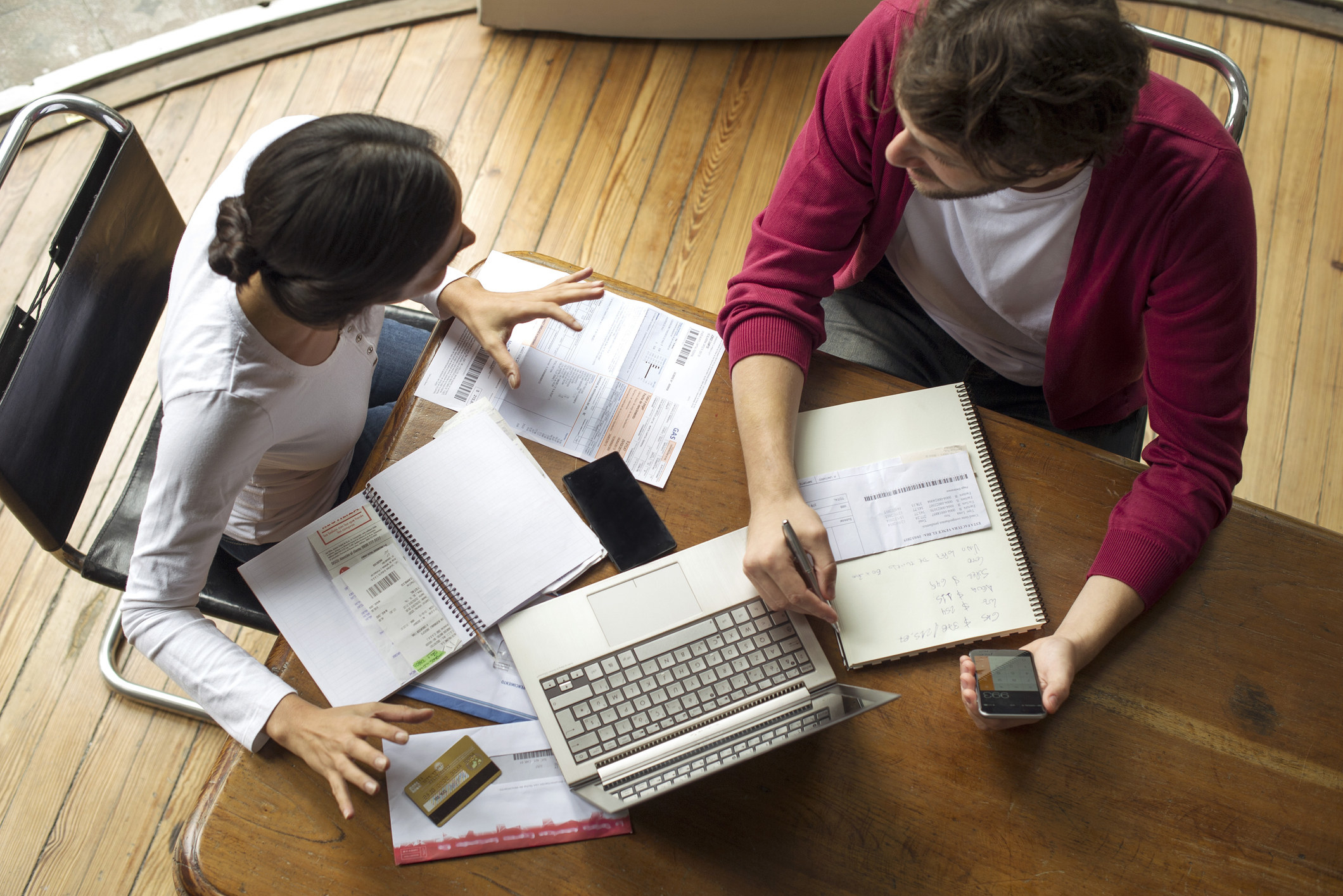 Couple arguing while looking at financial documents