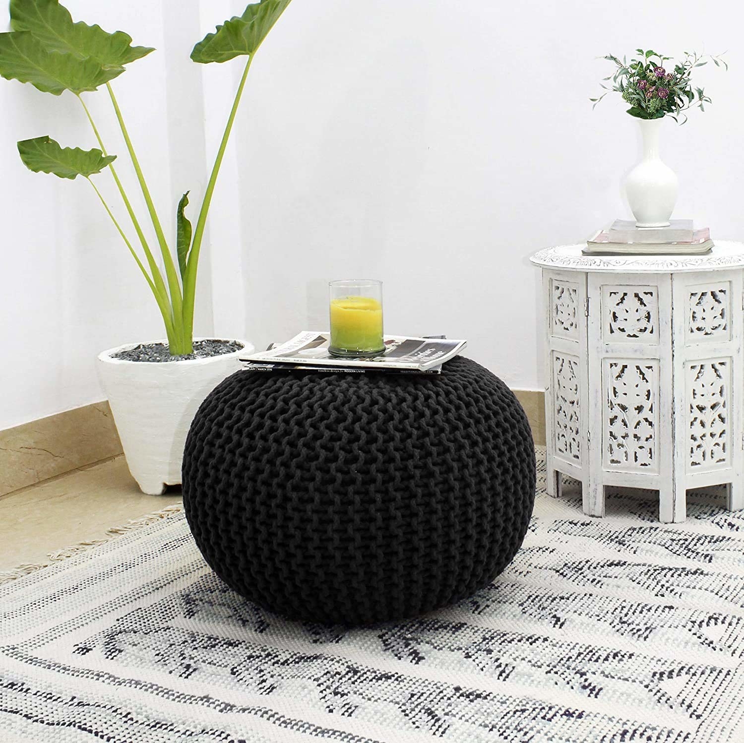 A black pouf on the floor 