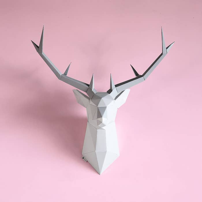 An origami deer head on a wall