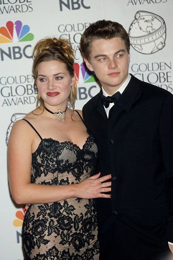 Kate in a lace spaghetti-strap gown standing next to Leo in a bow-tie