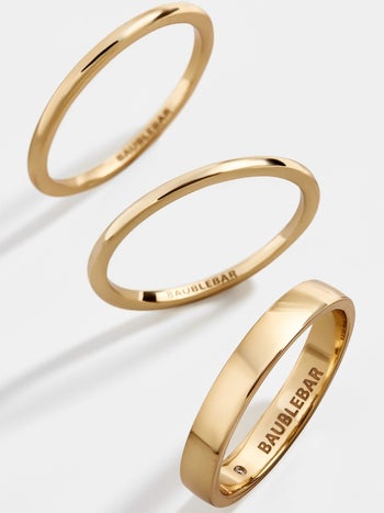 the three gold rings — two with skinny bands and one with a thicker band