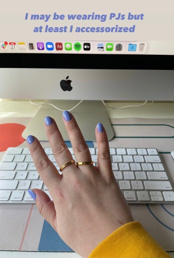 A BuzzFeed editor wearing three gold BaubleBar rings
