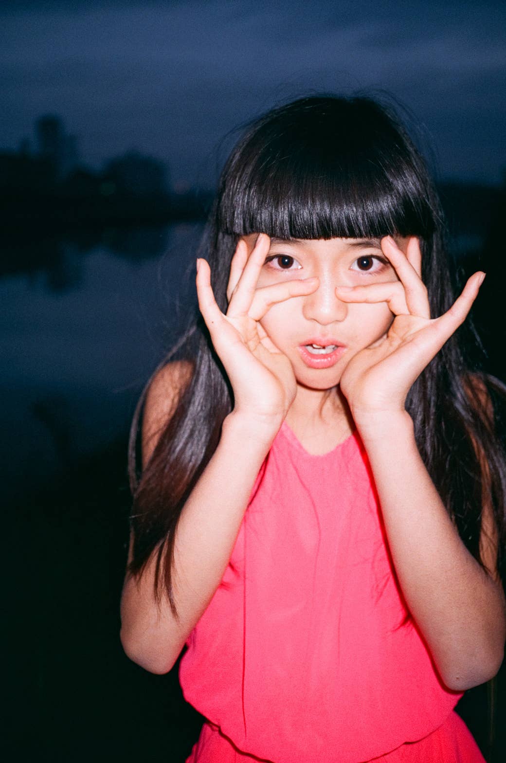 The photographer's daughter holding her hands up to her face