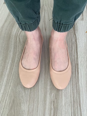Reviewer wearing blush Amazon ballet flats
