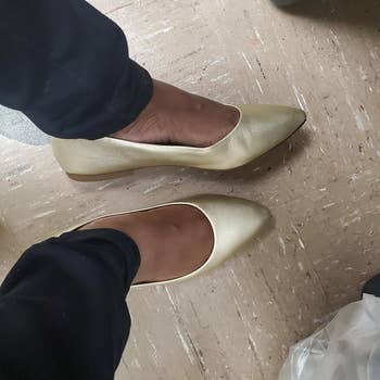 Reviewer wearing golden Amazon Essentials pointed toed flat