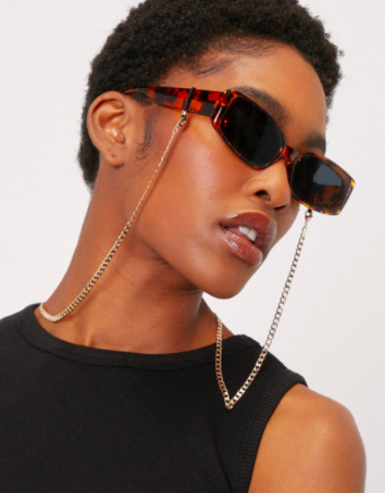 A person wearing sunglasses with the attached chain