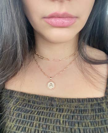 a different reviewer wearing the necklace with the initial 