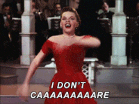 Gif of Judy Garland flailing her arms around while singing &quot;I don&#x27;t care!&quot; 