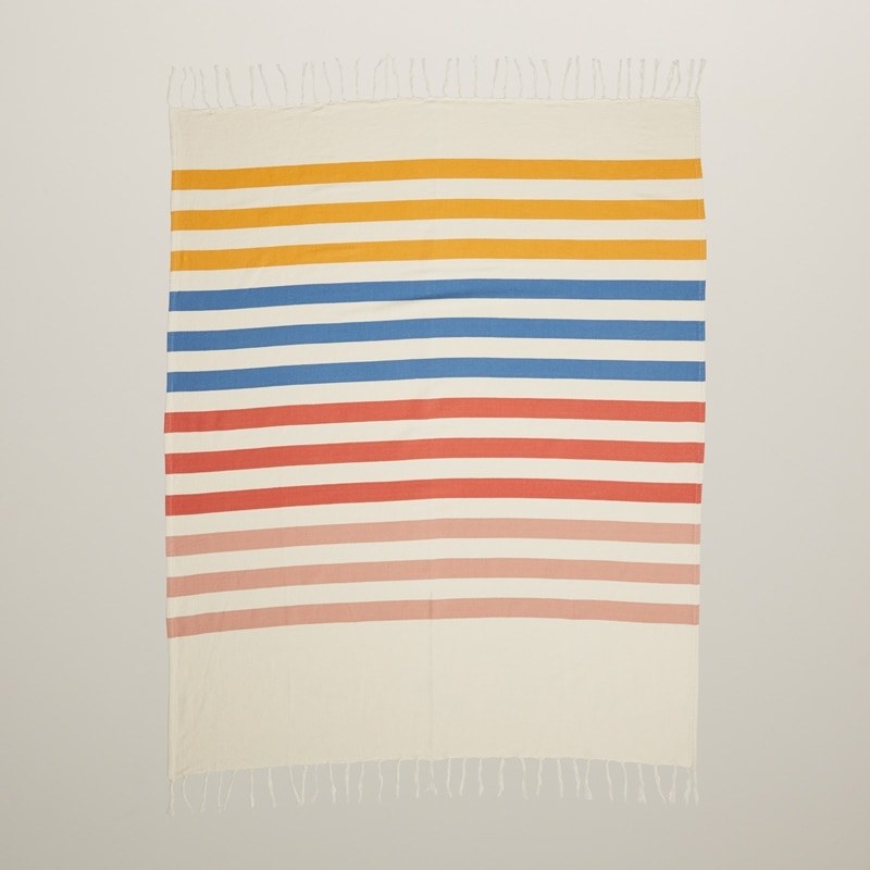A striped blanket with fringed hems