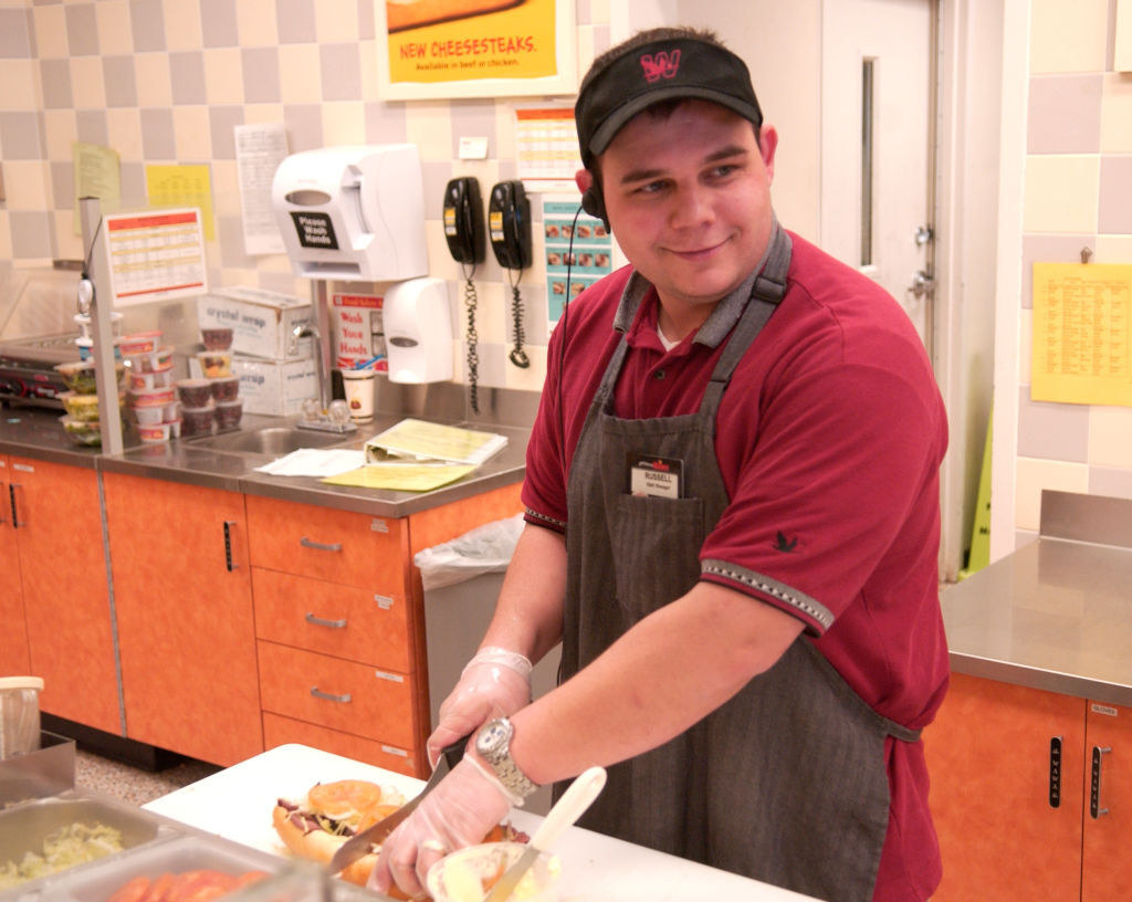 Wawa employee Russ Humes prepares a hoagie