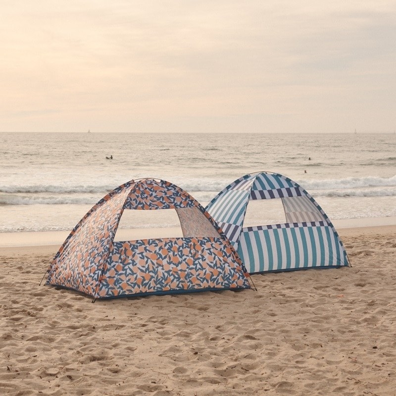 Two vibrant tents on a beach 