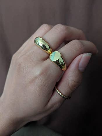 a reviewer wearing the plain dome ring and signet ring