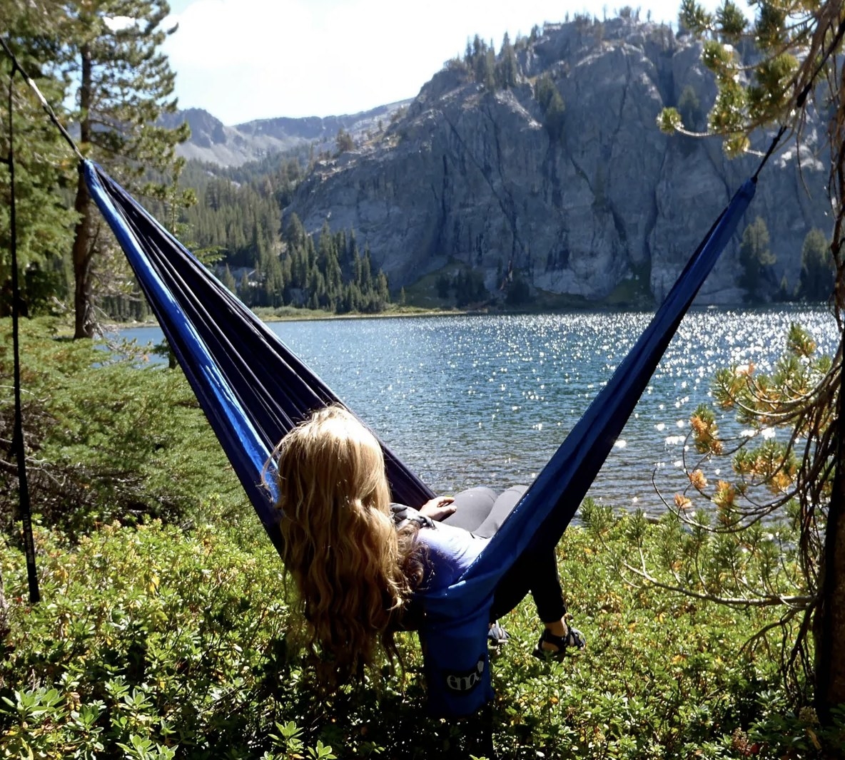 A person lounging on a hammock