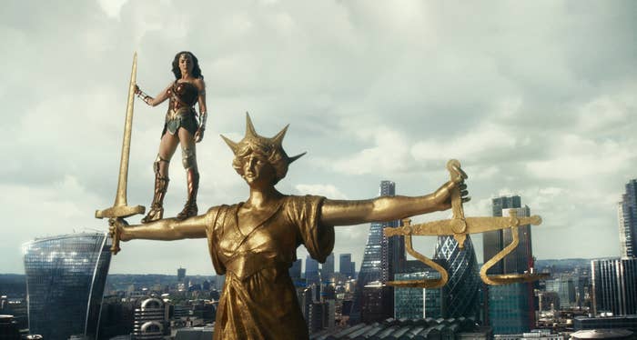 Gadot as Wonder Woman standing on top of a statue in Justice League