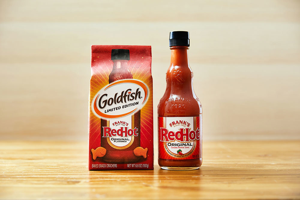 Frank&#x27;s RedHot Goldfish next to a bottle of Frank&#x27;s RedHot sauce
