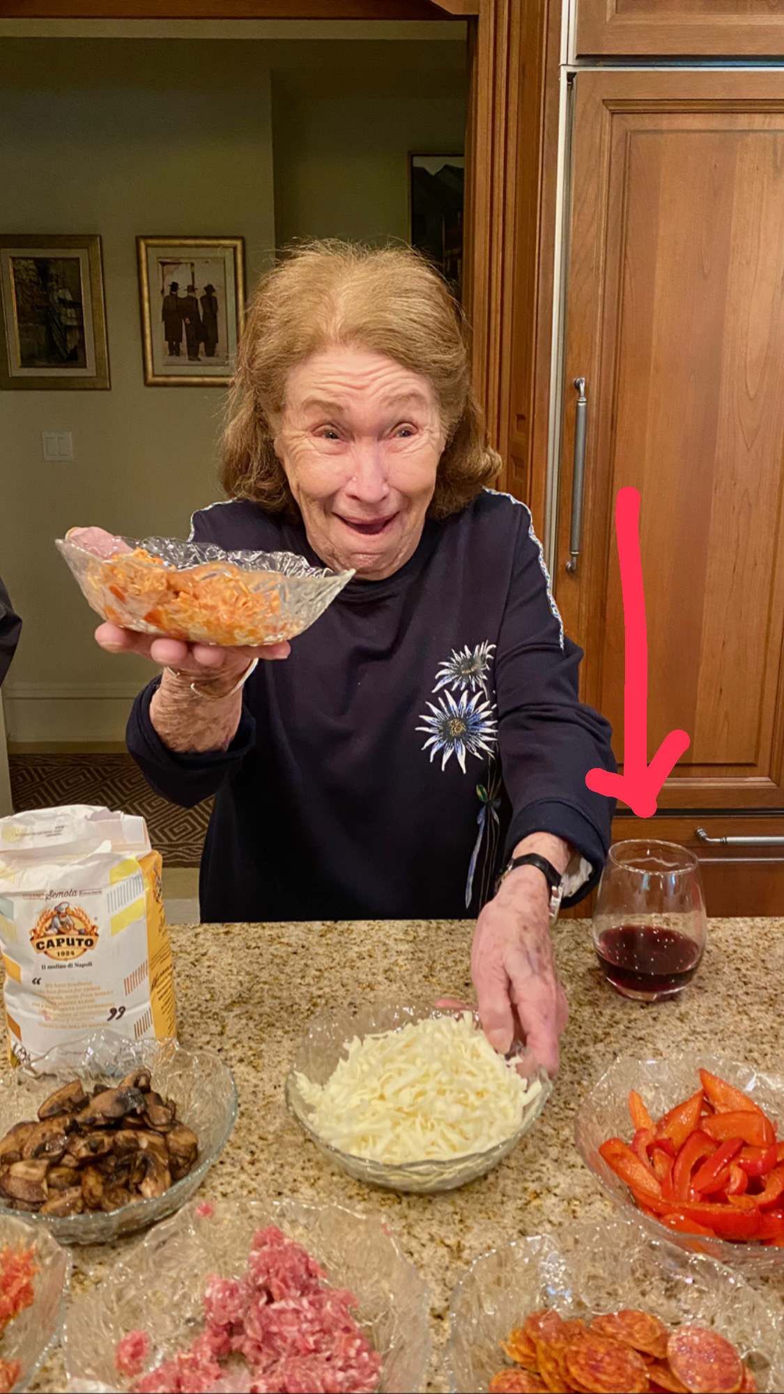 Grandma observing the various pizza toppings