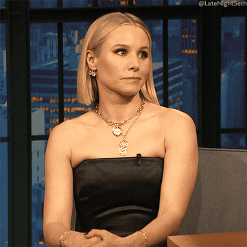 Kristen Bell shaking her head and wagging her finger no