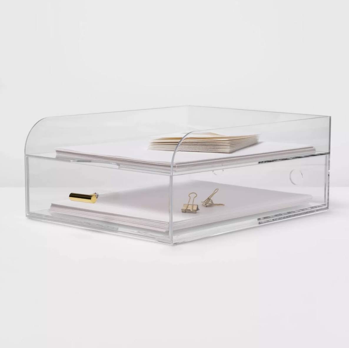 The clear tray has white paper and gold clips in the drawer and the top tray has white paper and envelopes