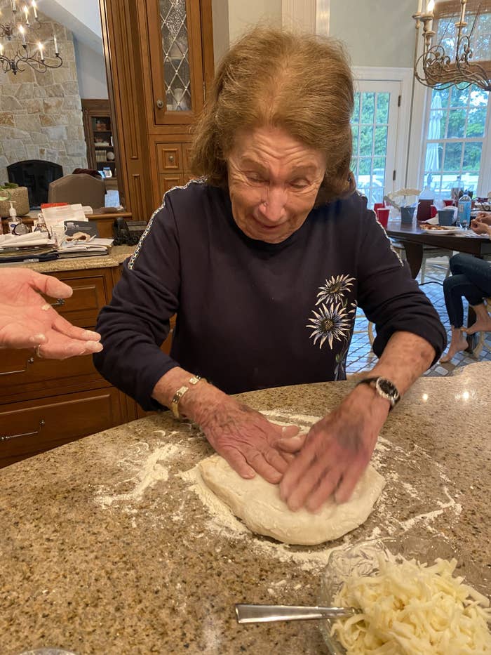 Grandma shaping her pizza dough into a pie