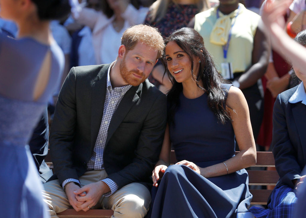 Prince Harry (L) and Meghan Markle watch a performance during their visit to Macarthur Girls High School