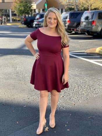 reviewer wearing the dress in maroon