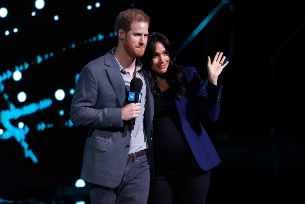 Prince Harry (L) and Meghan Markle speak on stage during WE Day UK 2019 