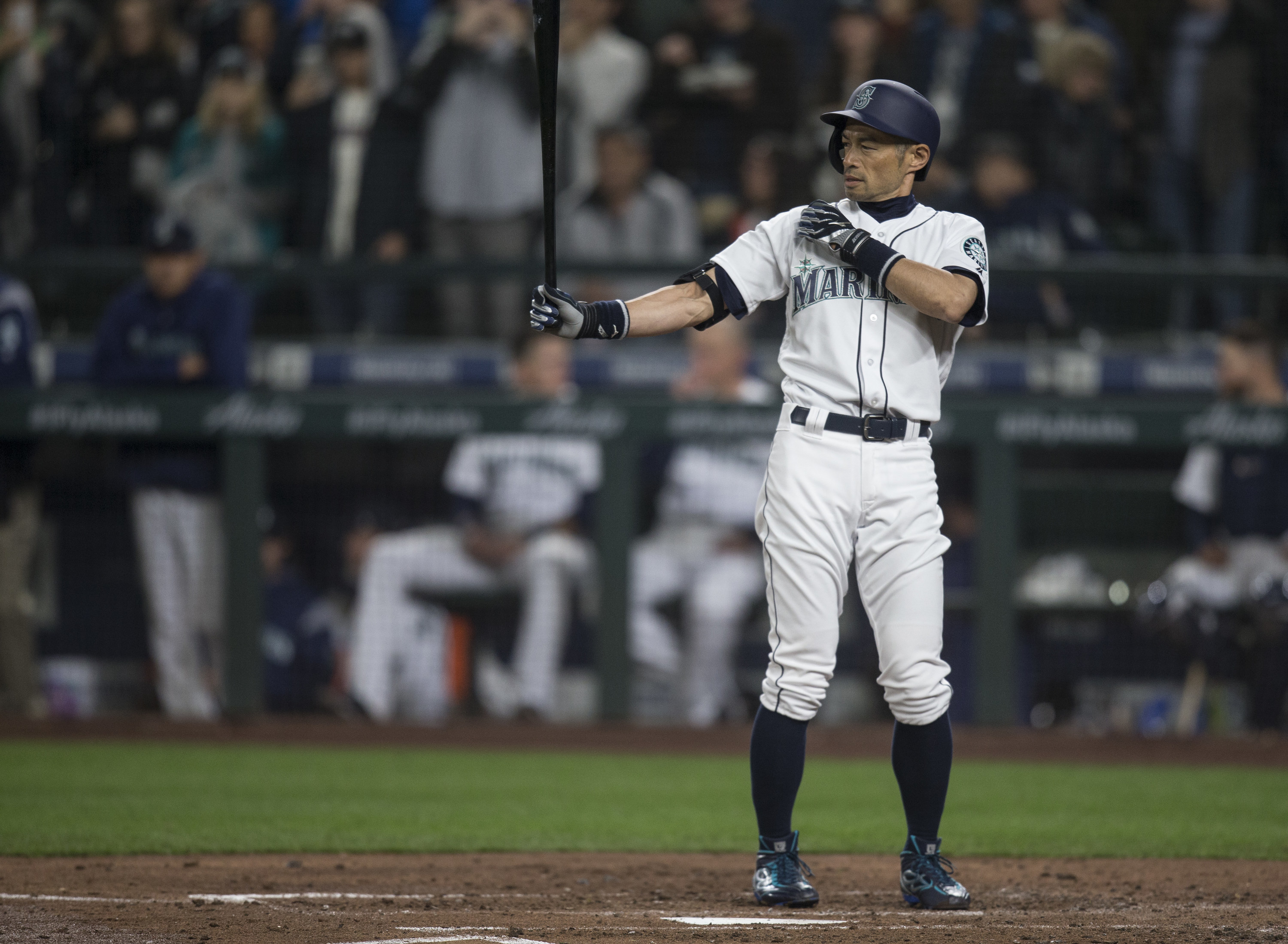 Ichiro Suzuki holding a baseball bat and waiting for the pitch