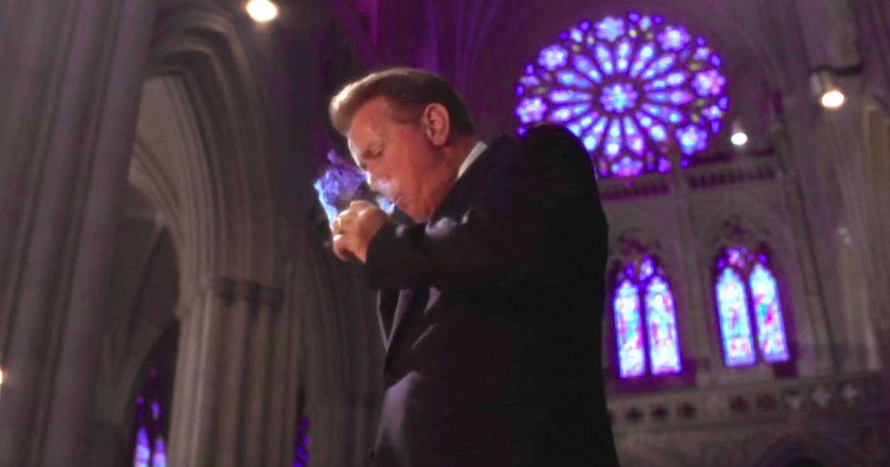 Bartlet smokes a cigarette in a cathedral
